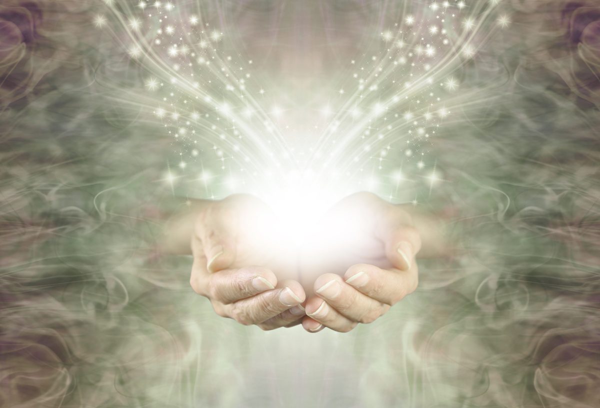 Open hands holding soft light